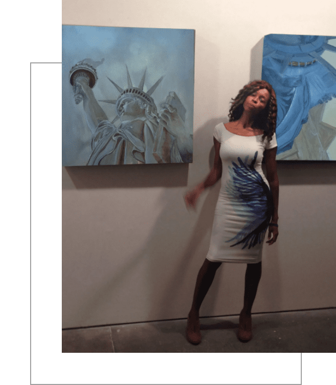 A woman standing in front of two paintings.